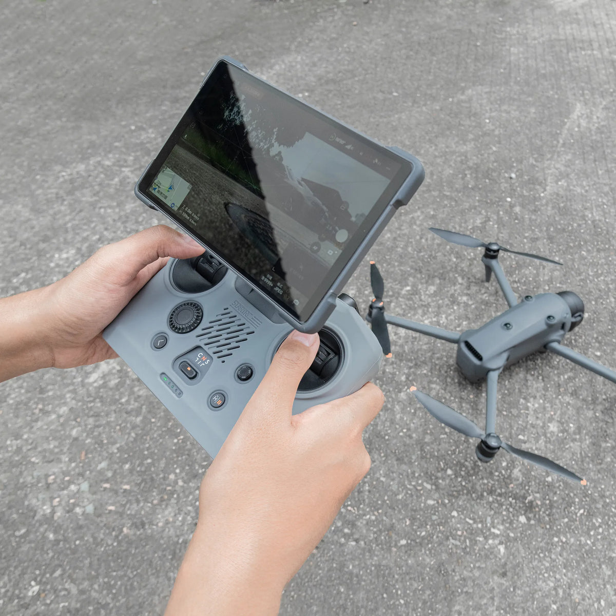 First-person view of holding the DJI RC PRO 2 remote, showcasing the soft skin-like feel and ergonomic anti-slip grip of the silicone cover.