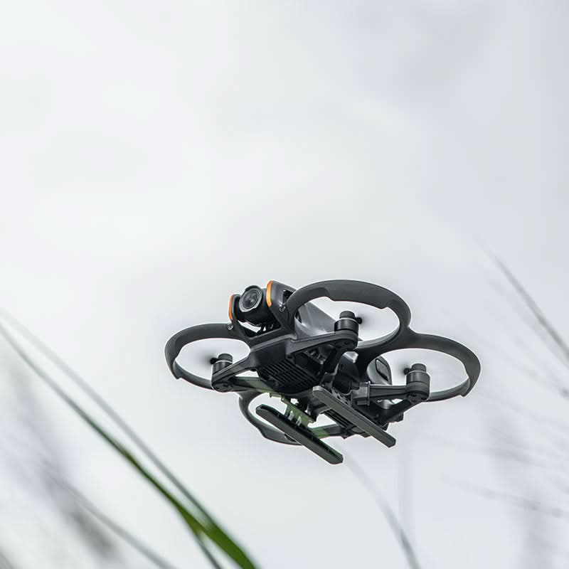 A DJI Avata 2 drone flying with the STARTRC foldable landing skids attached, demonstrating their aerodynamic and lightweight profile.