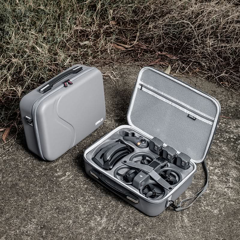 Professional FPV pilots using the DJI Avata 2 travel case in an outdoor setting, demonstrating its durability for daily transport.