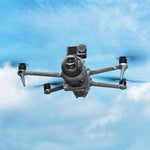 Aerial view of the DJI drone flying smoothly against a blue sky, carrying the smart airdrop system and an action camera without impacting obstacle avoidance.