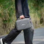 A creator walking outdoors with the STARTRC DJI Lito carry bag. The included adjustable shoulder strap makes it easy to grab and go on location.