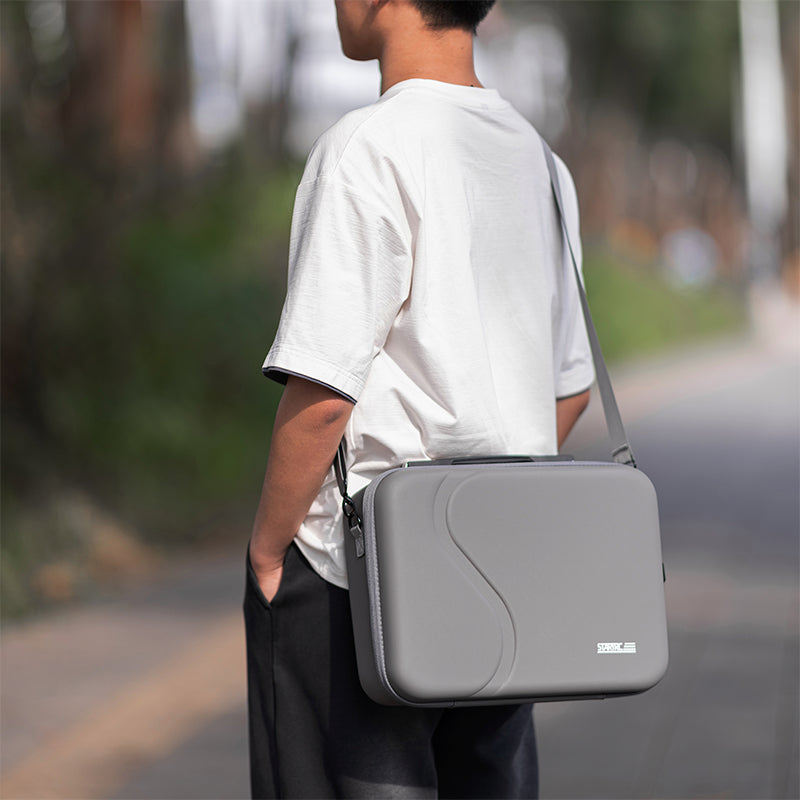 A man wearing the STARTRC DJI Neo 2 carrying case as a crossbody bag for hands-free outdoor travel and immersive flight sessions.