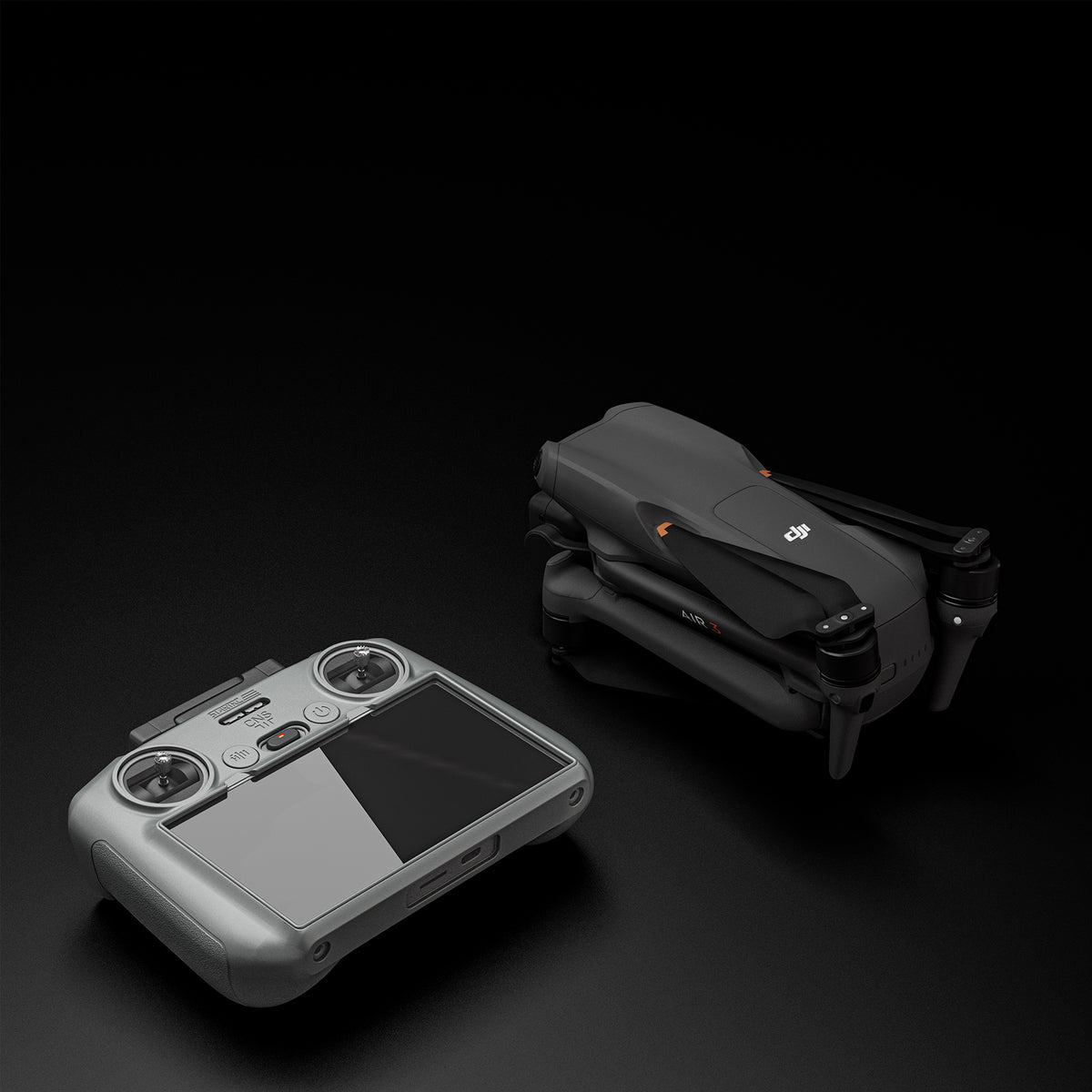 The DJI RC 2 remote in its STARTRC protective cover placed next to a DJI drone, ready for safe storage in crossbody bags or explosion-proof cases.