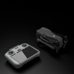 The DJI RC 2 remote in its STARTRC protective cover placed next to a DJI drone, ready for safe storage in crossbody bags or explosion-proof cases.