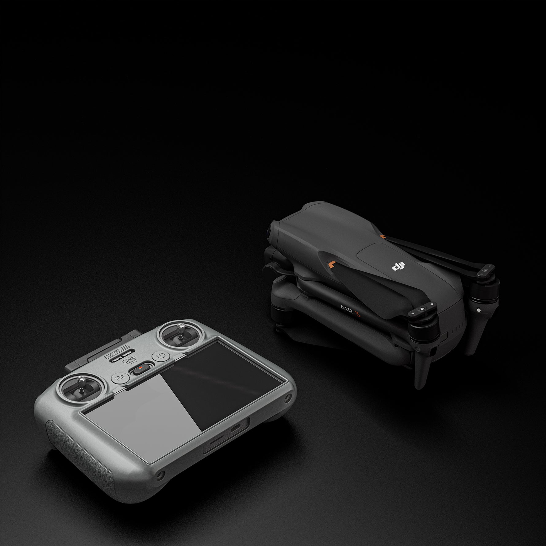 The DJI RC 2 remote in its STARTRC protective cover placed next to a DJI drone, ready for safe storage in crossbody bags or explosion-proof cases.