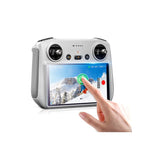 A pilot effortlessly swiping the DJI RC 2 remote screen, demonstrating the lag-free touch sensitivity and anti-smudge fingerprint-repelling finish.