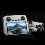 The DJI RC 2 display showing a bright, vivid landscape, illustrating the 100% light transmission and HD clarity preserved by the premium tempered glass.