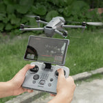 A drone pilot flying outdoors using the DJI RC PRO 2 protected by the STARTRC silicone cover, ensuring a secure grip in complex environments.