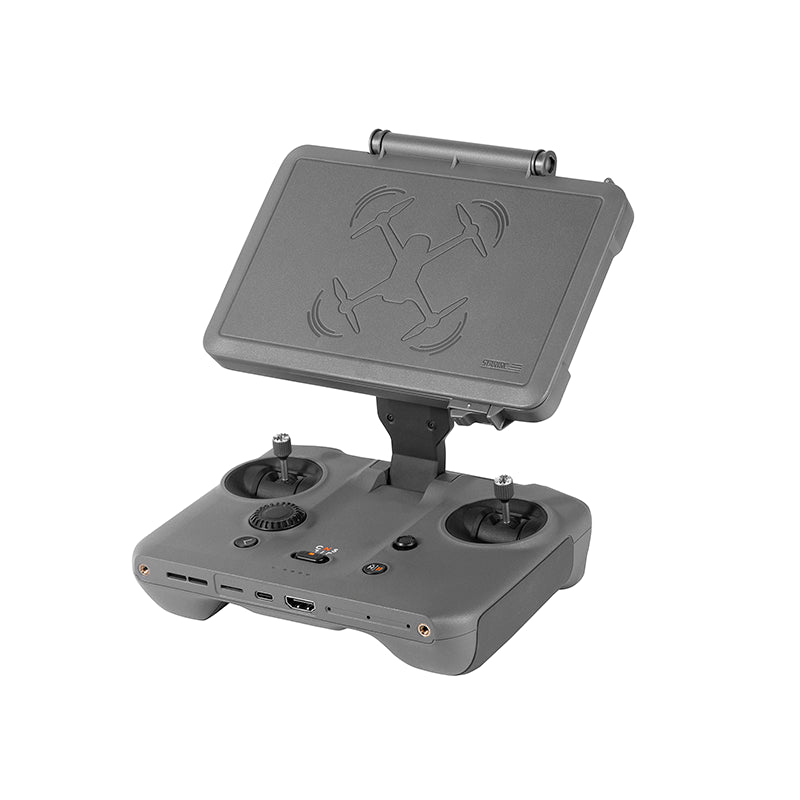 Grey STARTRC 2-in-1 sunshade and protective case installed on a DJI RC Pro 2 remote controller, showing the open anti-glare hood.