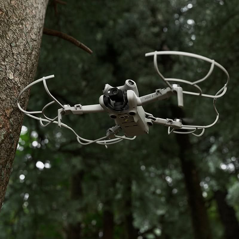 Camera drone navigating safely through a dense forest, utilizing the protective propeller enclosure to avoid damage from tree branches.