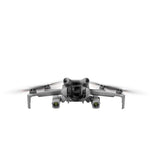 Front profile of a compact camera drone airborne with bright dual-side LED lights, enhancing visibility for travel creators and outdoor enthusiasts.