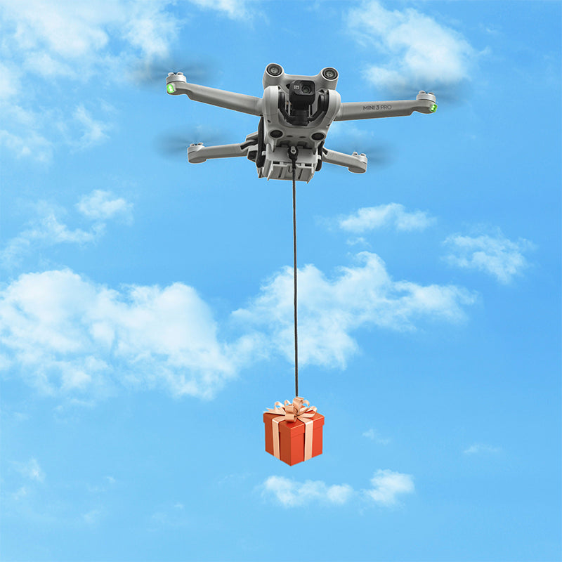 Aerial view of a DJI Mini drone executing a targeted cargo delivery against a blue sky, requiring no extra remote controllers for operation.