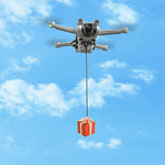 Aerial view of a DJI Mini drone executing a targeted cargo delivery against a blue sky, requiring no extra remote controllers for operation.