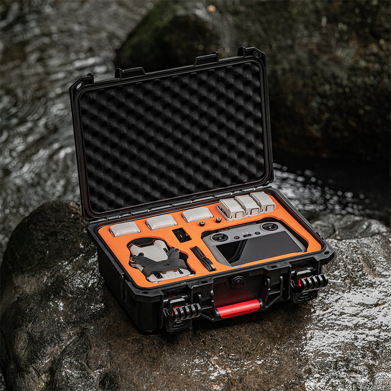 The rugged waterproof hard case resting safely on wet outdoor rocks, tested by professional aerial filmmakers for real-world durability in extreme conditions.