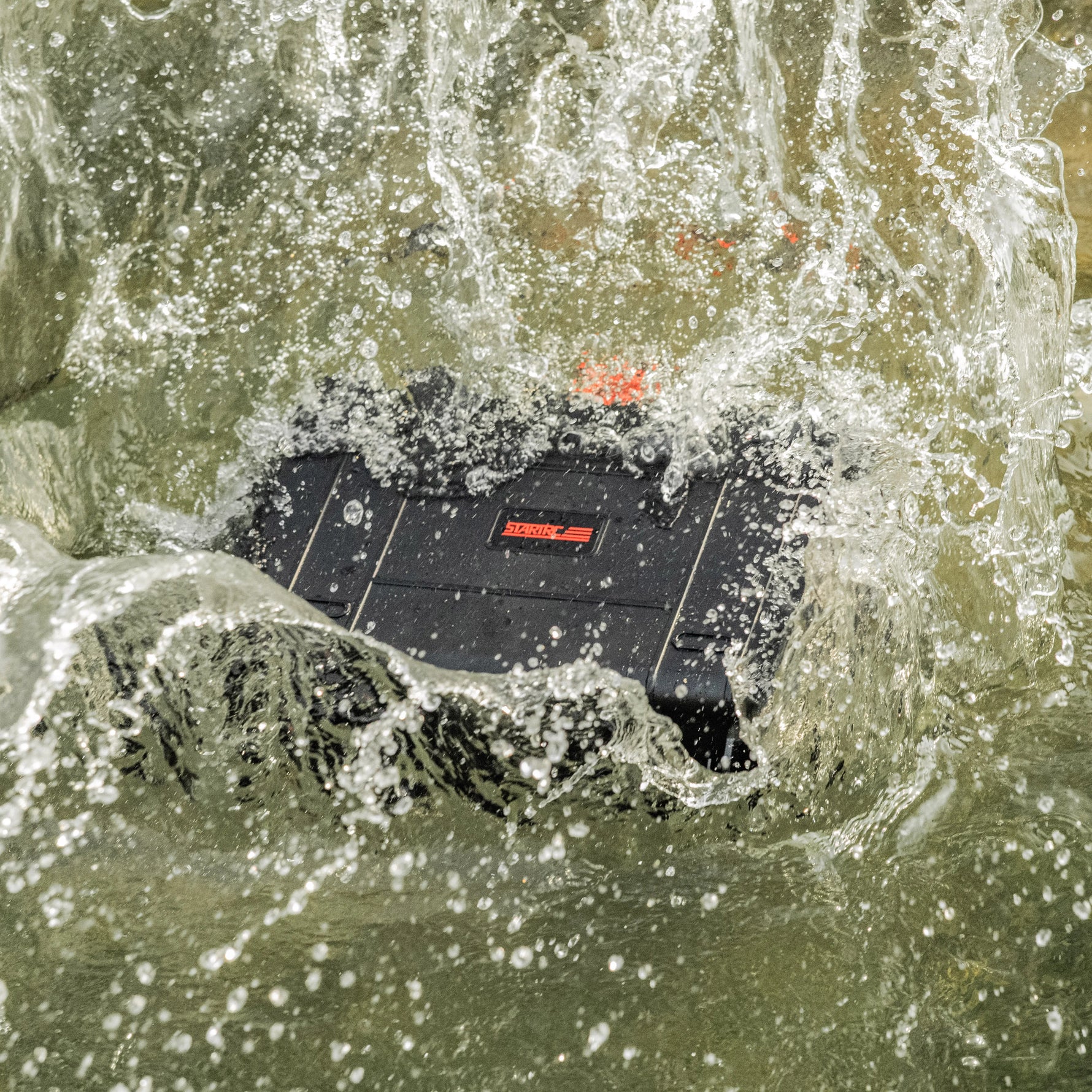 The STARTRC DJI Avata 2 case undergoing a splash test to demonstrate its IP67 waterproof rating, keeping high-value drone gear dry in extreme environments.