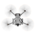 Bottom view of the DJI Mini 4 Pro flying smoothly with the illuminated landing gear, maintaining perfect flight dynamics and maneuverability.
