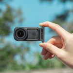 User holding the DJI Osmo Nano horizontally with the STARTRC frame attached, demonstrating its sleek and minimalist profile that stays completely out of the shot.
