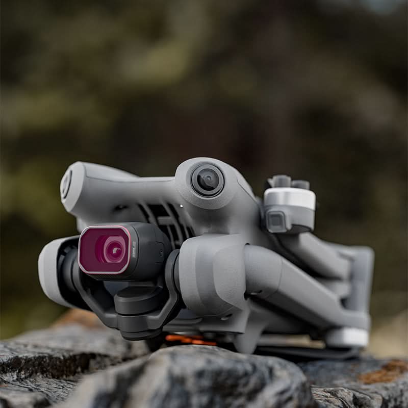 DJI drone resting on an outdoor rock with the waterproof lens filter attached, ensuring easy maintenance and reliability in diverse environments.