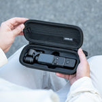 A user holding the portable STARTRC Pocket 4 case, demonstrating its compact size and easy carry for outdoor adventures or travel.