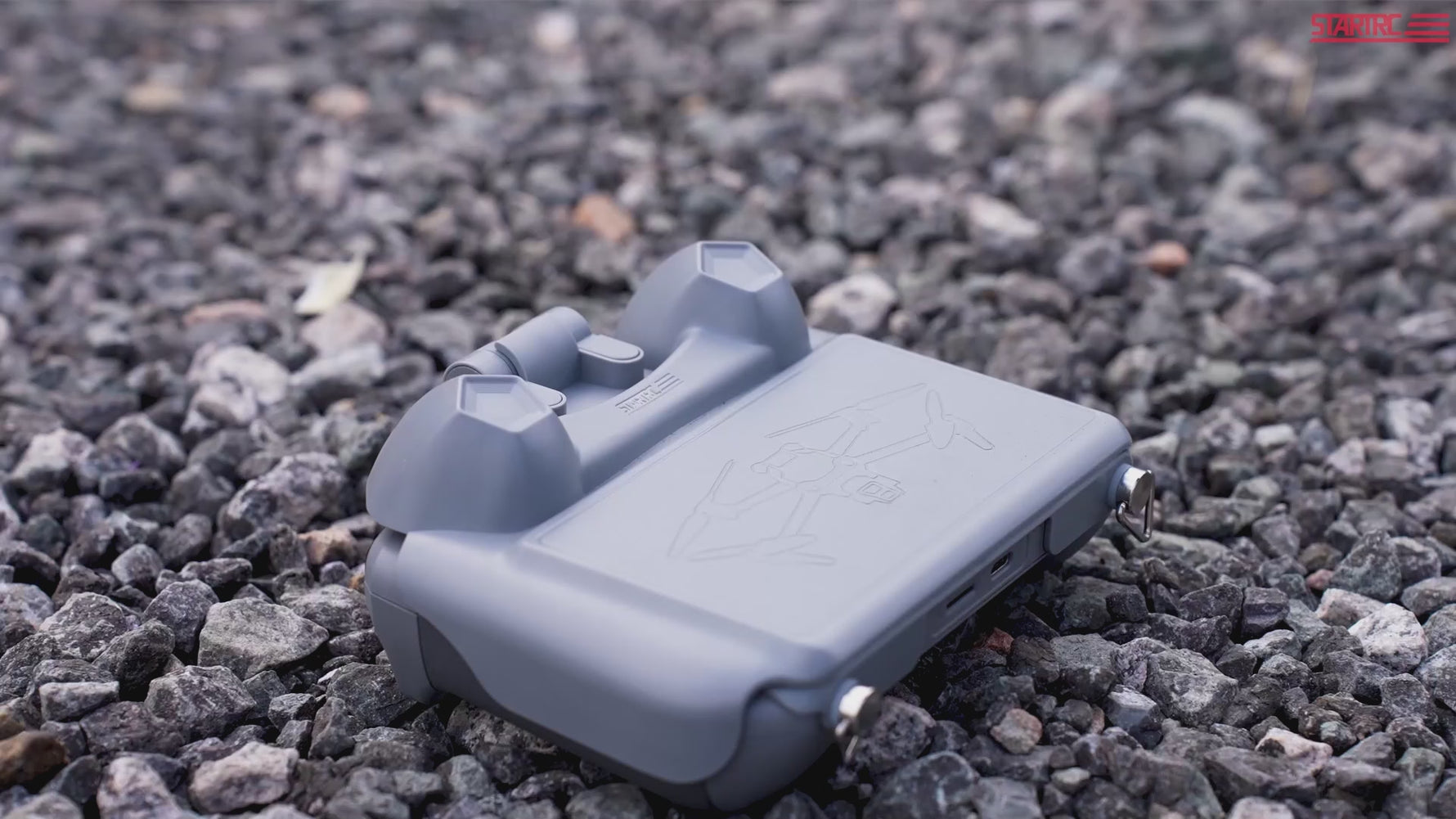 Video thumbnail showing the scratch-resistant screen guard and joystick cover protecting the DJI remote on rough outdoor terrain.