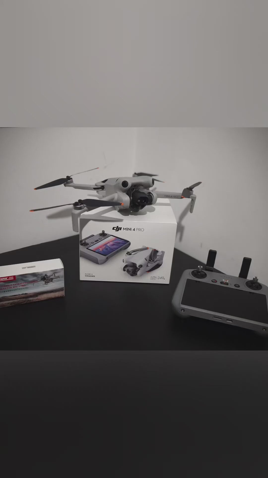 Vertical video thumbnail showing the quick installation and unboxing of essential DJI drone accessories on a studio desk.