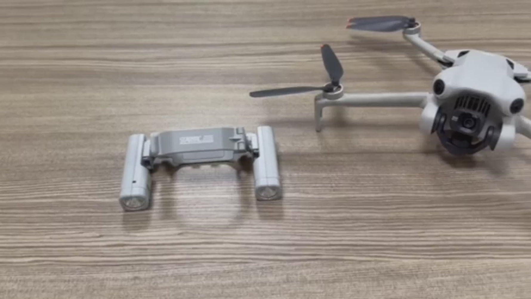 Video tutorial thumbnail showcasing the quick, tool-free installation of the LED light kit onto the DJI Mini 4 Pro on a wooden desk.