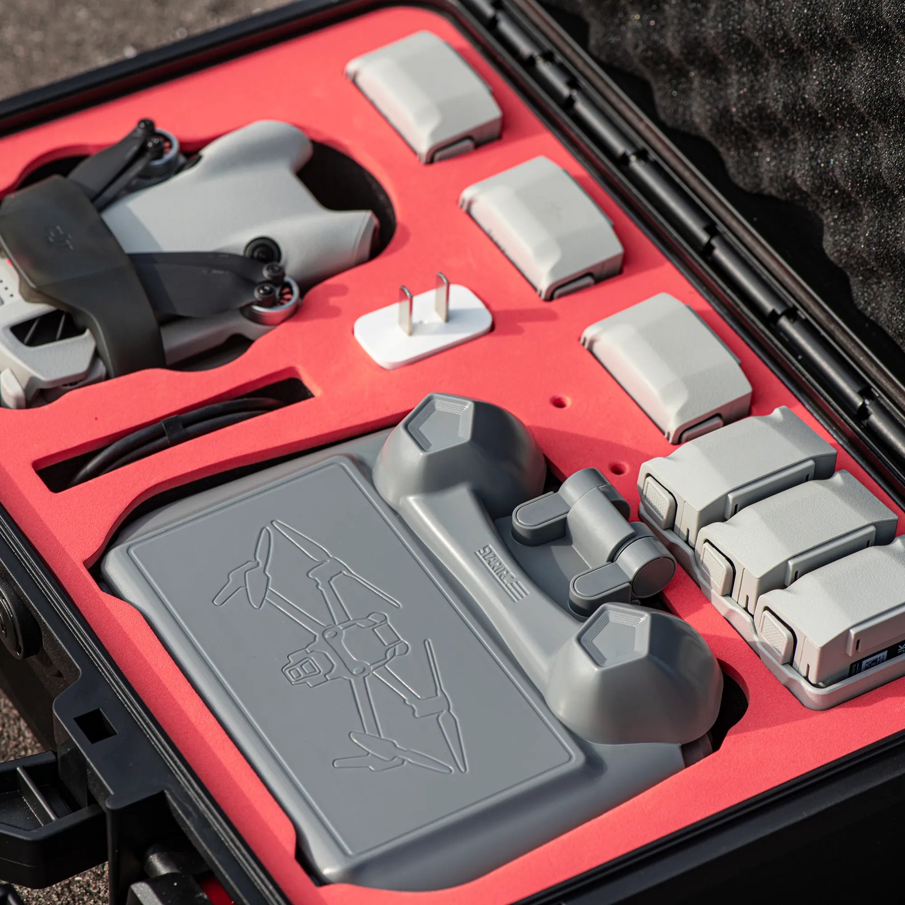 Compact drone controller sunshade securely packed inside a travel hard case, protecting joysticks from accidental presses during storage.