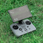 The DJI RC PRO 2 remote controller resting safely on outdoor grass, shielded from dirt, dust, and scratches by the shockproof silicone case.