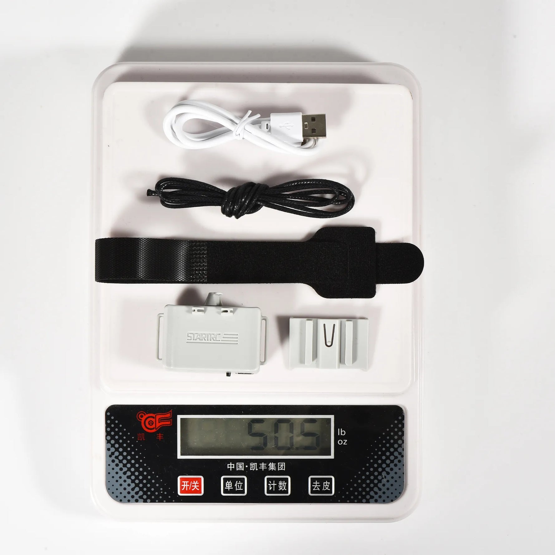 Digital scale displaying the complete ultralight drone airdrop kit and charging cable, preserving your delivery efficiency and flight time.