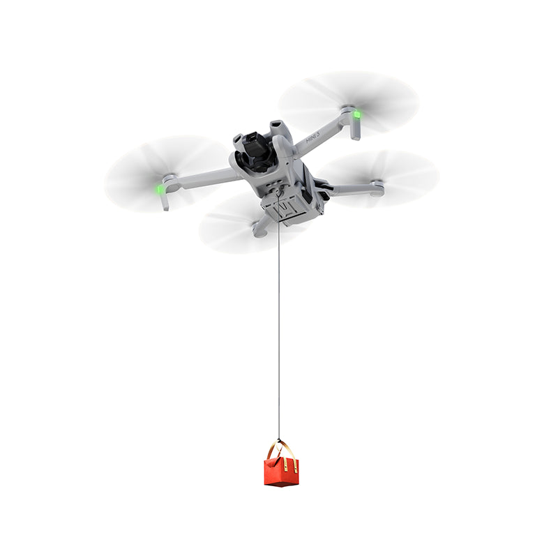 DJI Mini series drone equipped with a universal airdrop system, utilizing 10-second precision drop technology to deliver a red gift box mid-air.