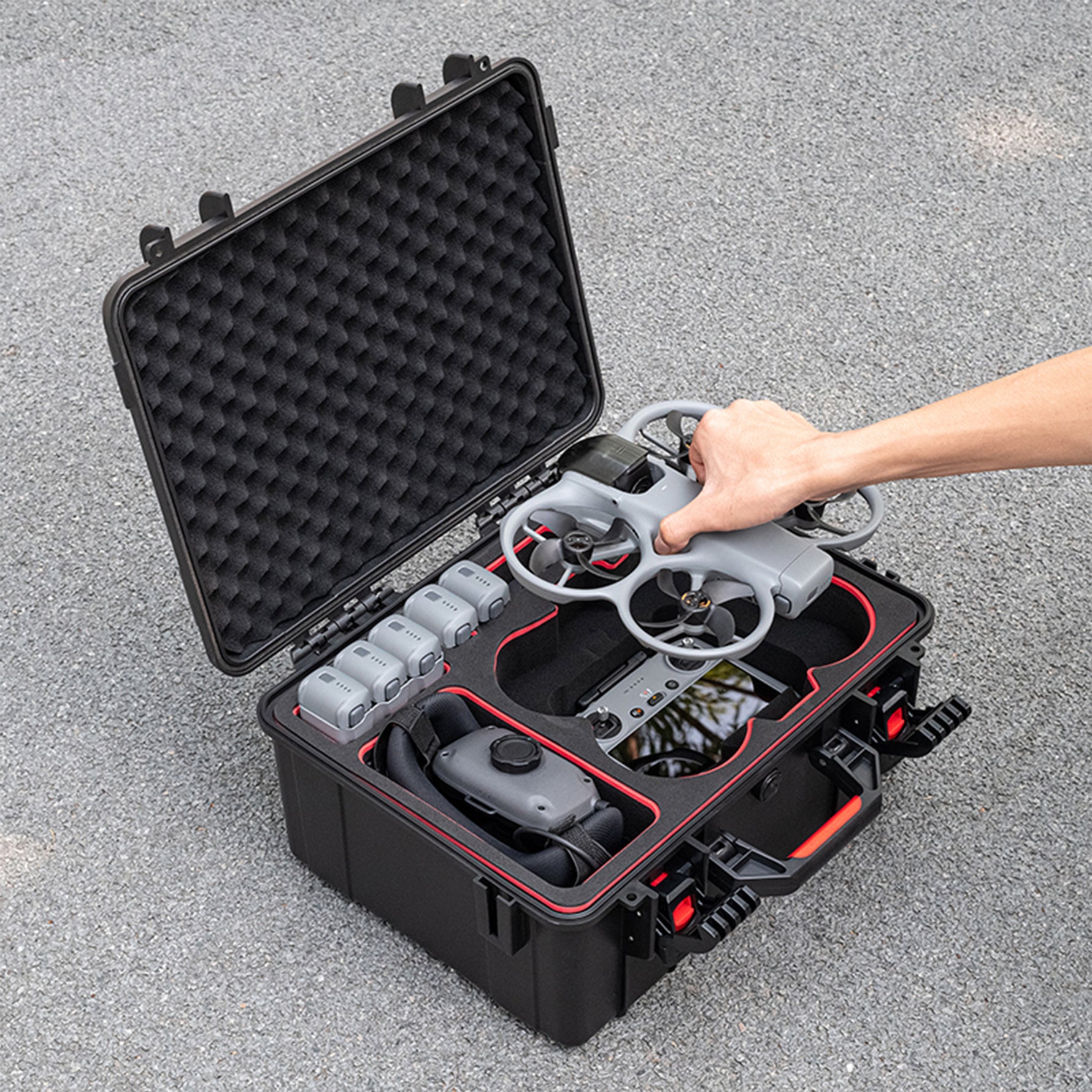 A pilot easily removing the DJI Avata 360 from the hard case without detaching the gimbal guard, ready for quick flight.